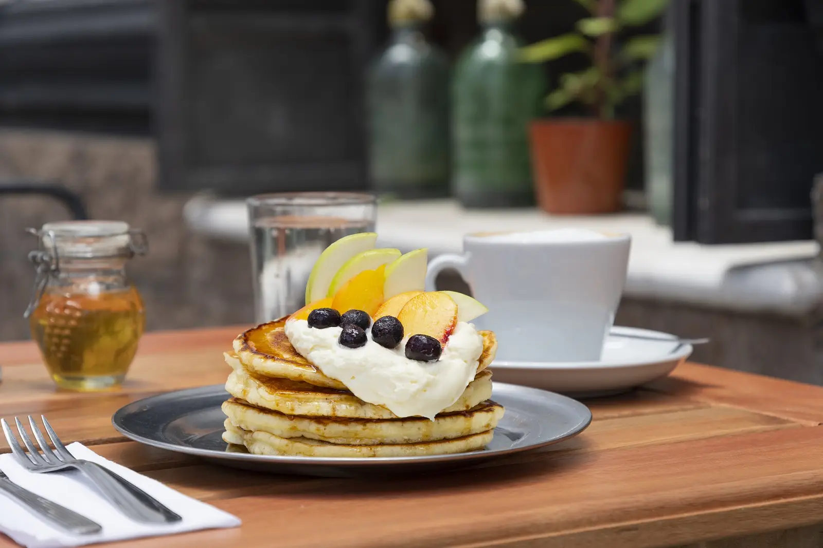 Pancakes and coffee on a cafe table. The photo was not taken at an Alpharetta restaurant.