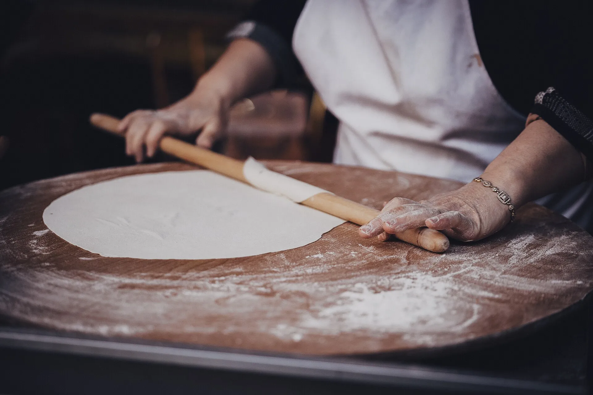 A cook rolls out gozleme dough, the stuffed Turkish flatbread that is on the festival menu.