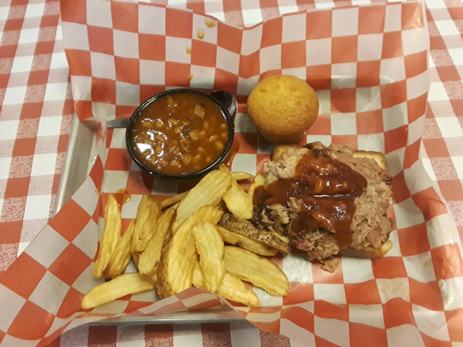 A pulled pork plate with beans, fries and a corn muffin at a Famous Dave's restaurant in Virginia. The picture does not show the State Bridge Road location.